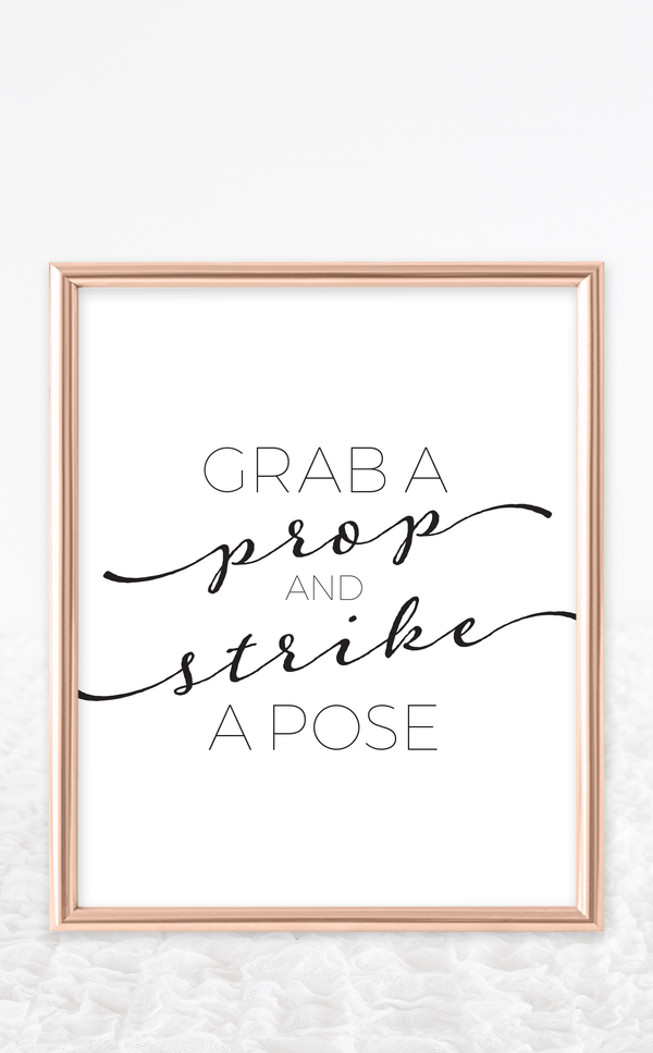 Black and White printable Photo booth sign that says Grab a Prop and Strike a Pose
