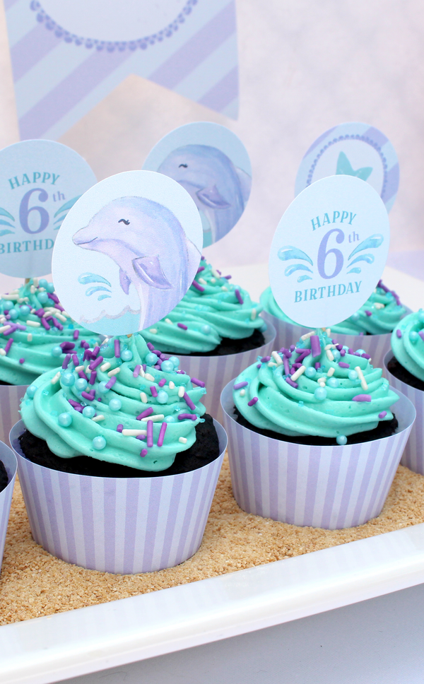 Purple and teal dolphin cupcakes on graham cracker crumbs for kids birthday party
